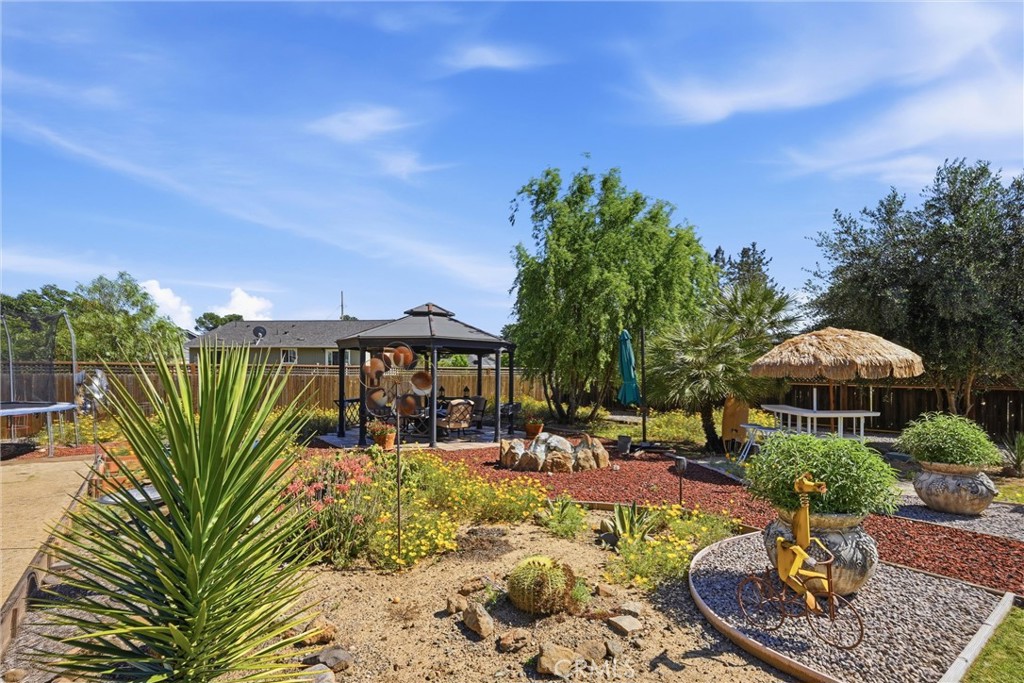 18650 Horseshoe Road Hidden Valley Lake, CA 95467 - Photo 24 of 26 a view of a swimming pool with lawn chairs under an umbrella