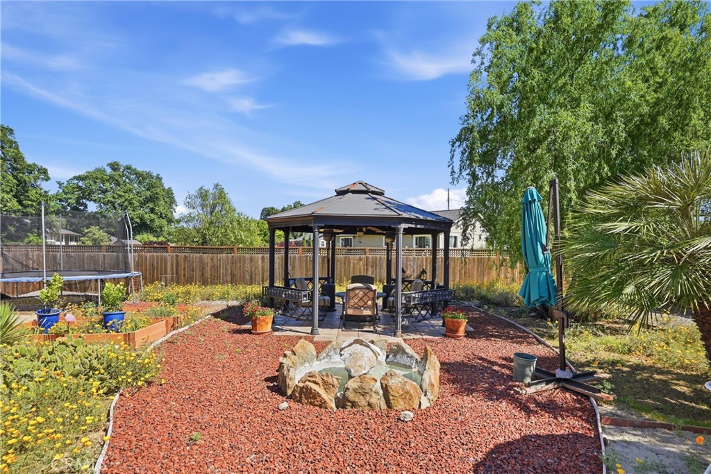 18650 Horseshoe Road Hidden Valley Lake, CA 95467 - Photo 25 of 26 a view of a patio with table and chairs potted plants and large tree
