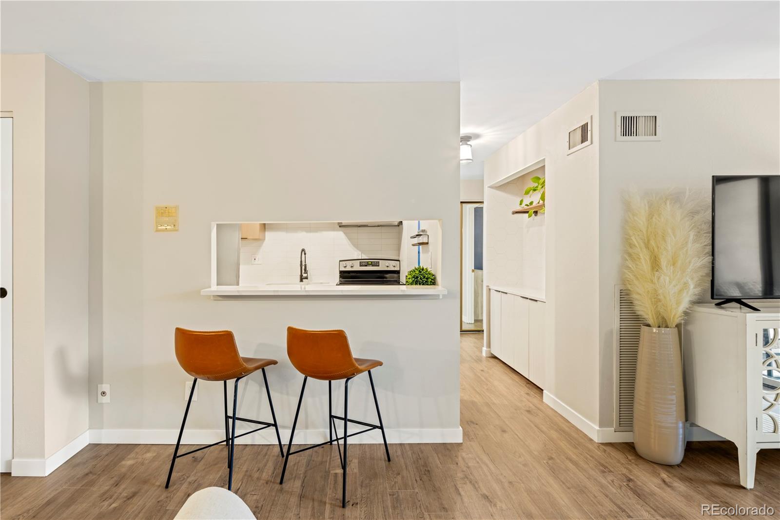 2 Adams Street, Unit 108 Denver, CO 80206 - Photo 11 of 36 a view of kitchen with furniture and wooden floor