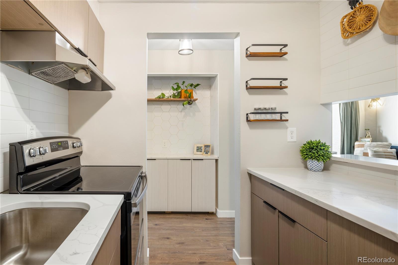 2 Adams Street, Unit 108 Denver, CO 80206 - Photo 15 of 36 a kitchen with a refrigerator and a stove top oven