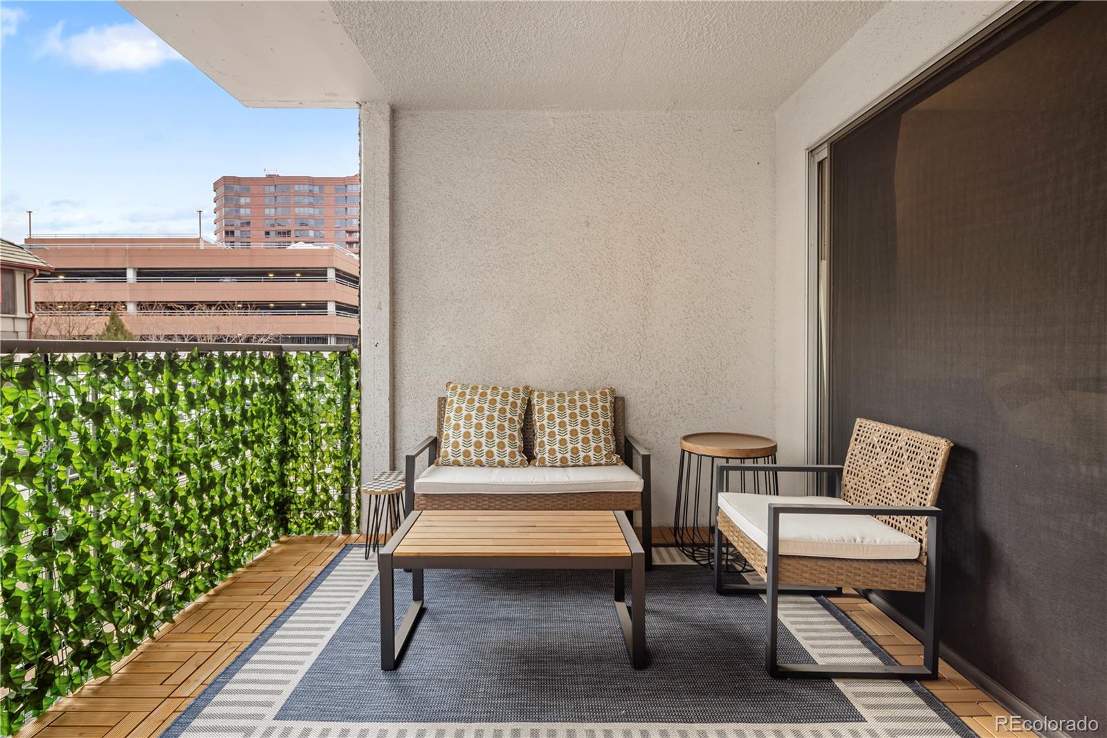 2 Adams Street, Unit 108 Denver, CO 80206 - Photo 2 of 36 a balcony with wooden benches and a rug