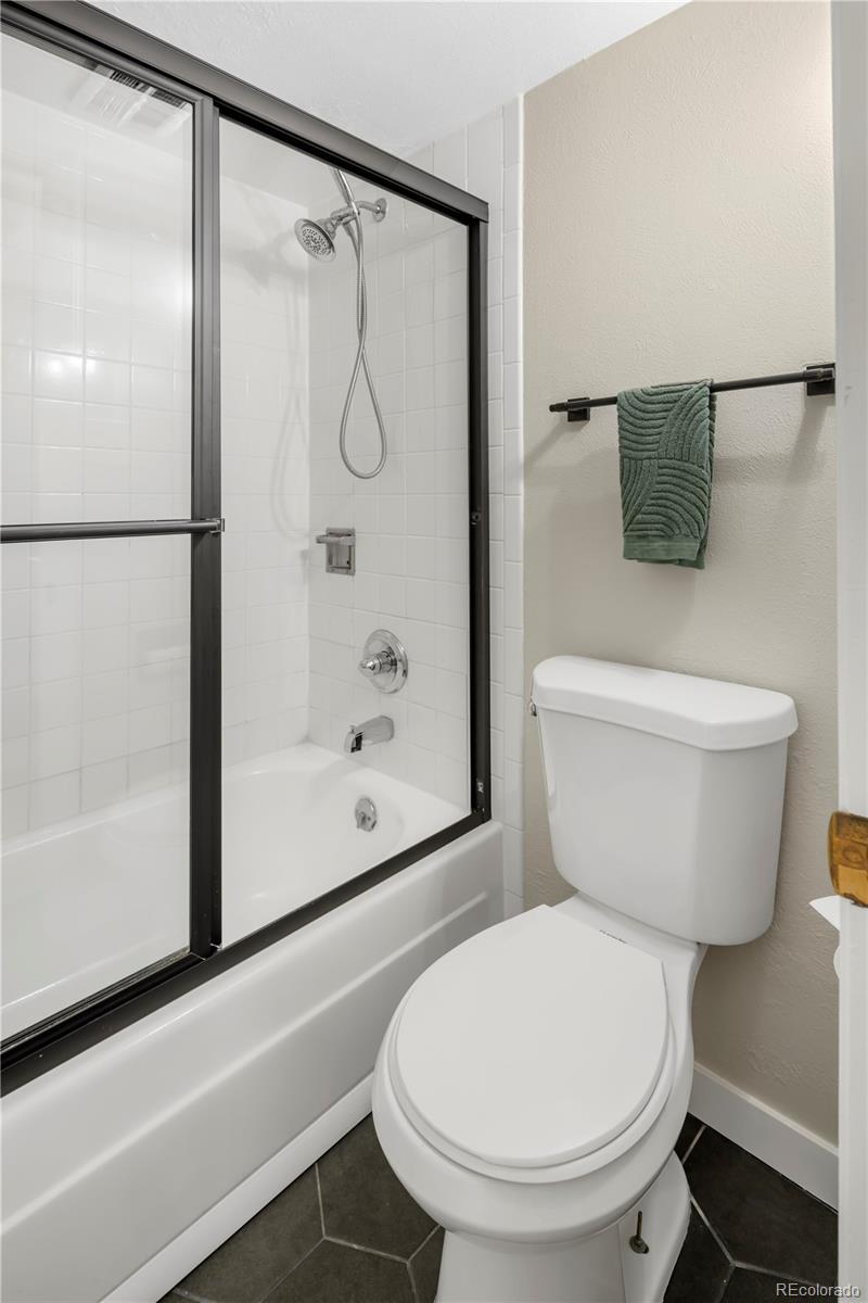 2 Adams Street, Unit 108 Denver, CO 80206 - Photo 25 of 36 a bathroom with a toilet and a shower