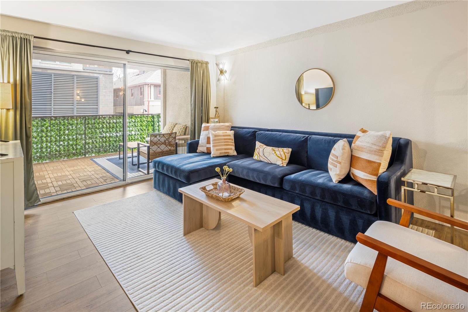 2 Adams Street, Unit 108 Denver, CO 80206 - Photo 3 of 36 a living room with furniture and a large window
