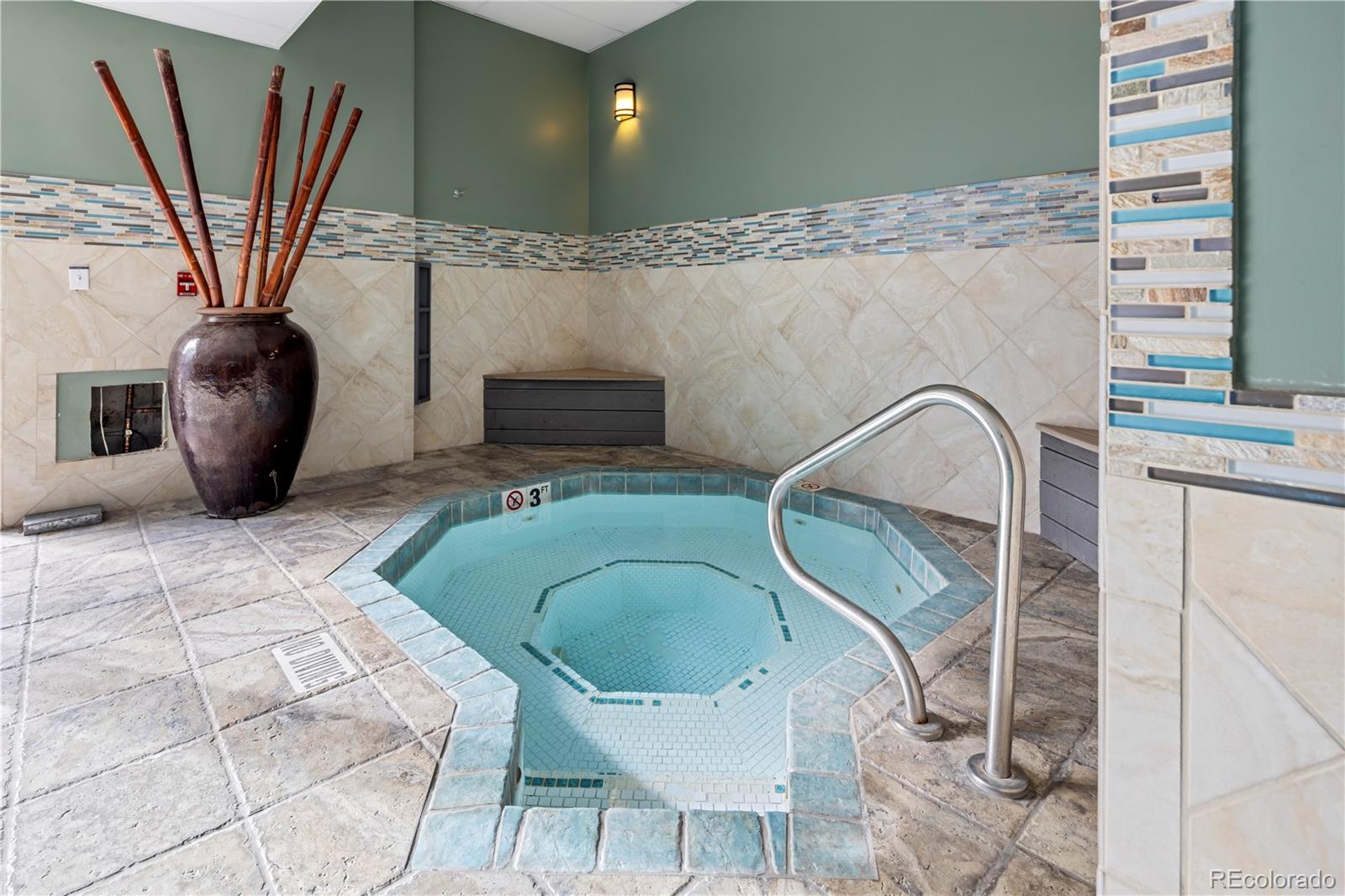 2 Adams Street, Unit 108 Denver, CO 80206 - Photo 32 of 36 a living room with furniture a flat screen tv and a fireplace