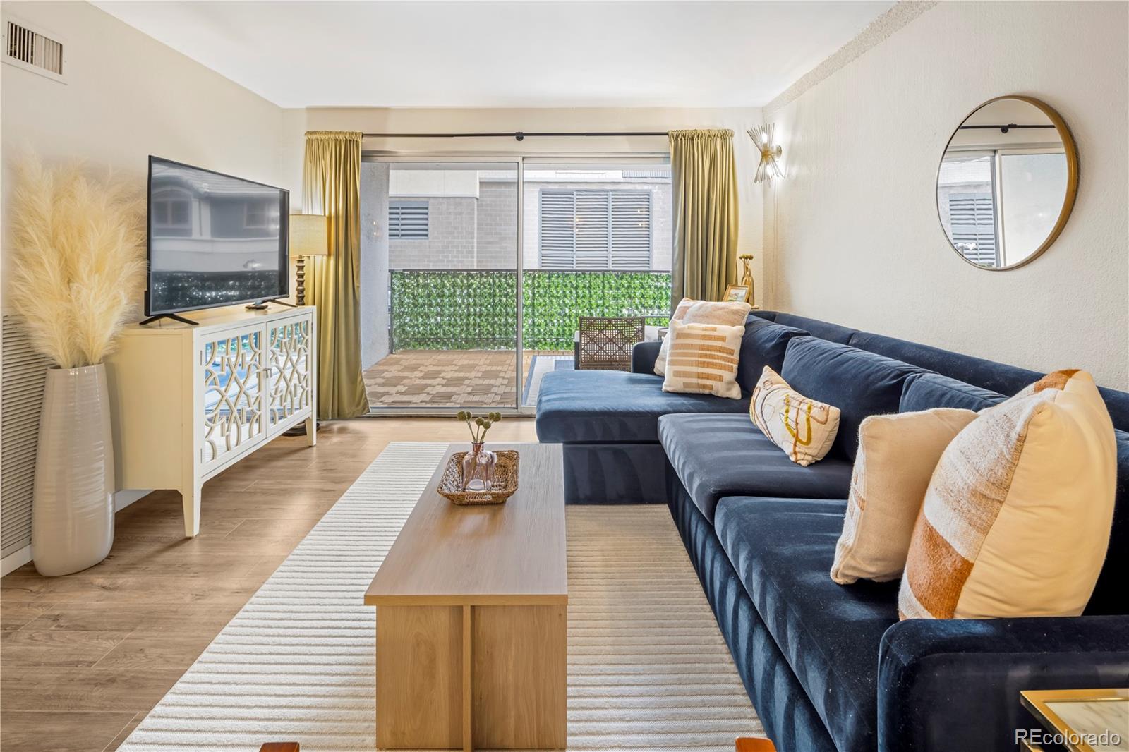 2 Adams Street, Unit 108 Denver, CO 80206 - Photo 7 of 36 a living room with furniture and a wooden floor