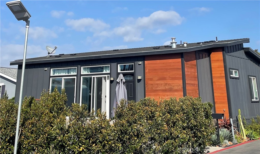 a view of a house with a small yard and floor to ceiling window