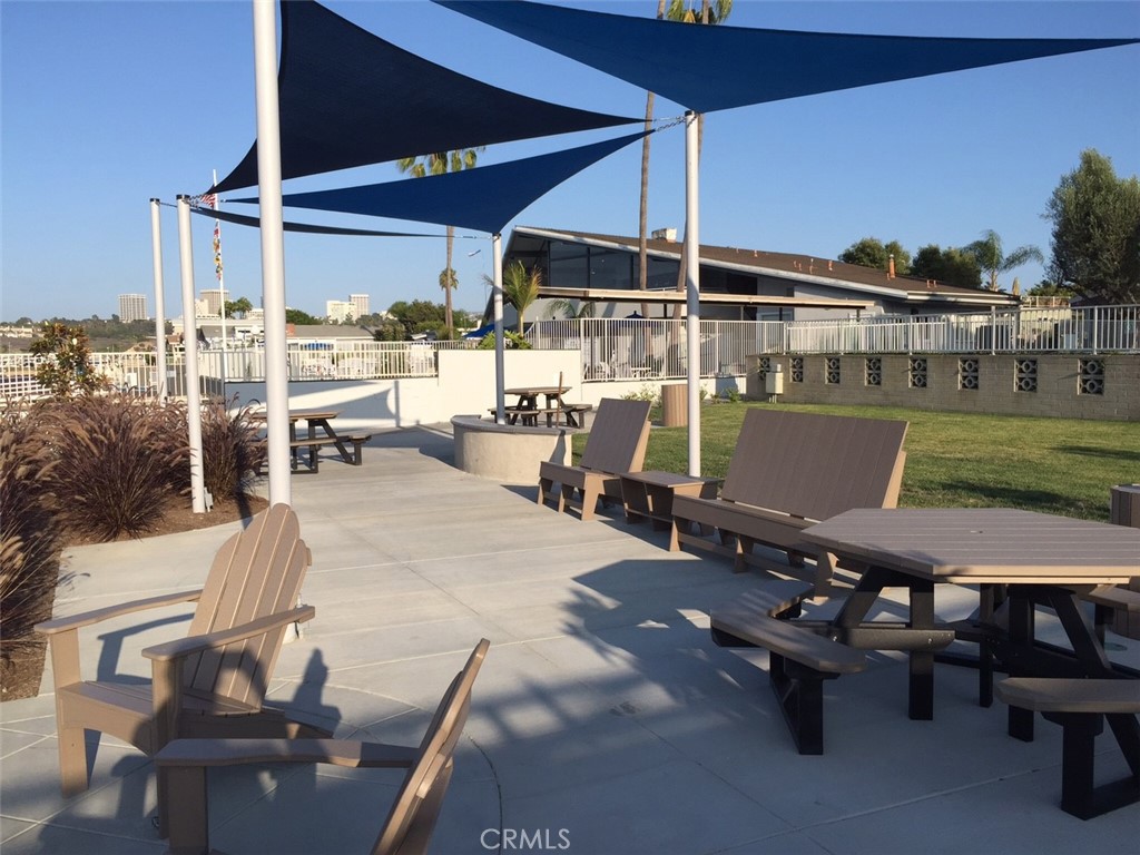 283 Cambridge Way Newport Beach, CA 92660 - Photo 21 of 33 a view of a patio with table and chairs