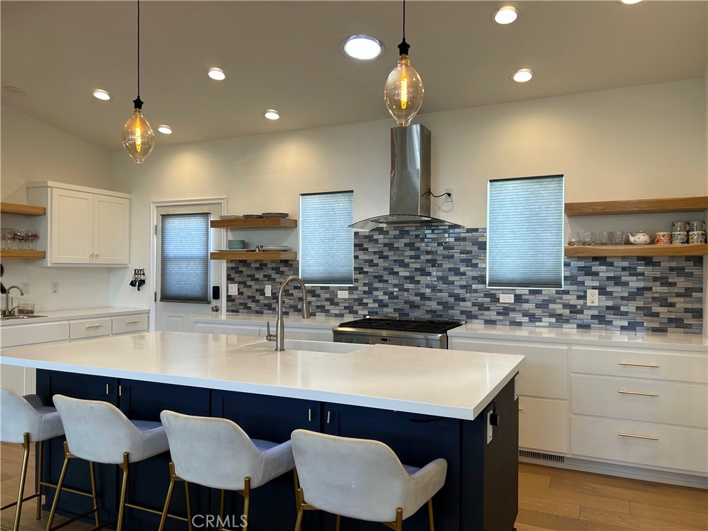 283 Cambridge Way Newport Beach, CA 92660 - Photo 4 of 33 a kitchen with a table chairs sink and cabinets