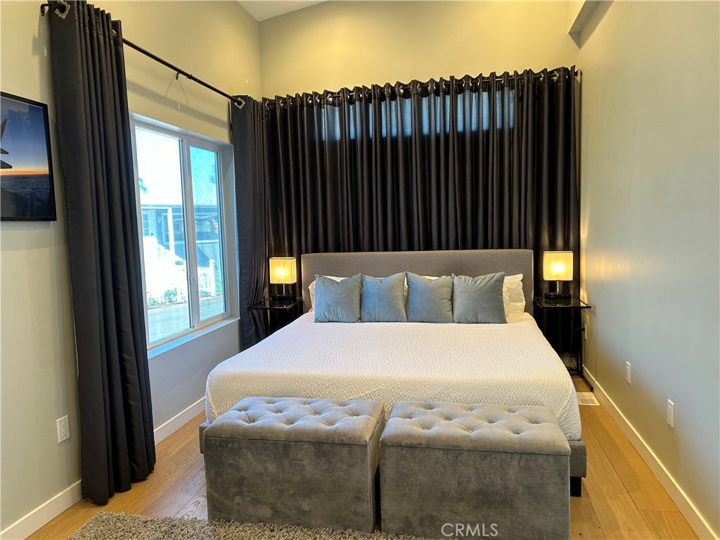 283 Cambridge Way Newport Beach, CA 92660 - Photo 6 of 33 a large white bed in a bedroom next to a window