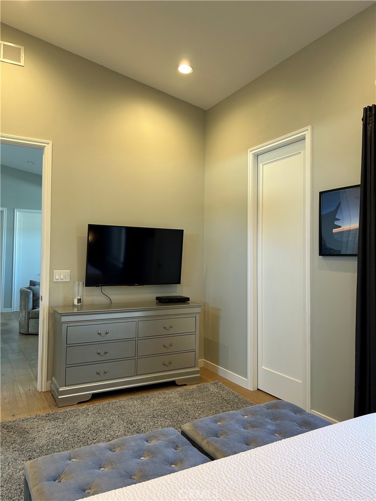 283 Cambridge Way Newport Beach, CA 92660 - Photo 7 of 33 a living room with hard wood floor and a flat screen tv