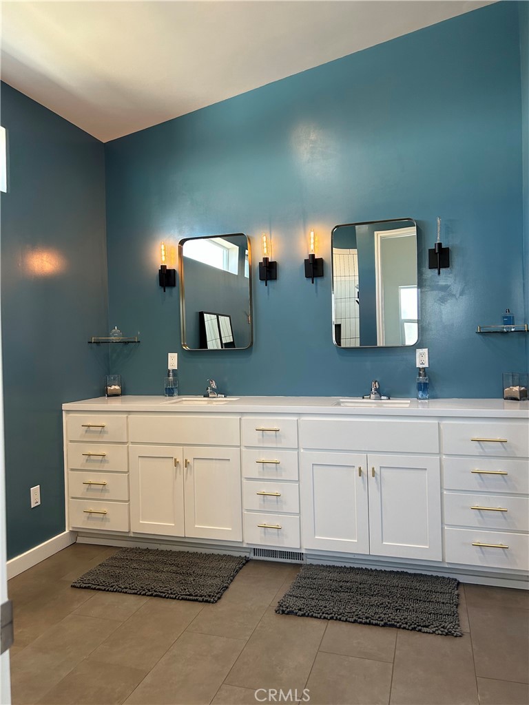 283 Cambridge Way Newport Beach, CA 92660 - Photo 8 of 33 a bathroom with a sink and mirror