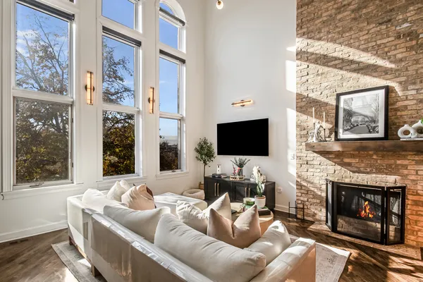 a living room with furniture a fireplace and a flat screen tv