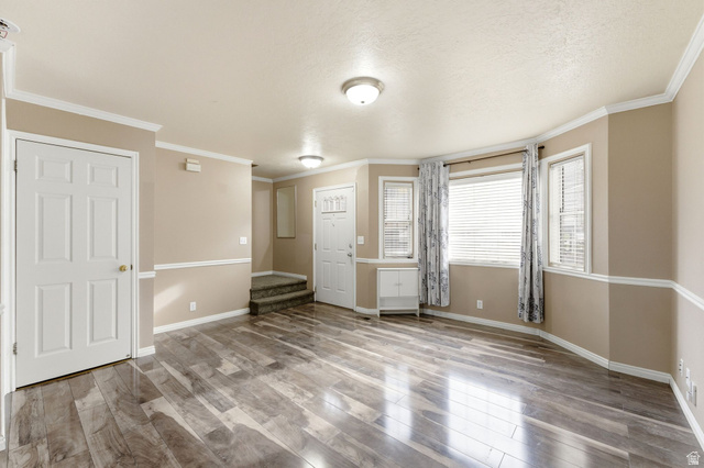 1052 South 950 East, Unit 33 Provo, UT 84606 - Photo 3 of 12 Unfurnished bedroom featuring light wood-style flooring and ornamental molding