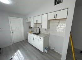 1981 Rutland Street Opa-Locka, FL 33054 - Photo 2 of 3 a kitchen with sink cabinets and window