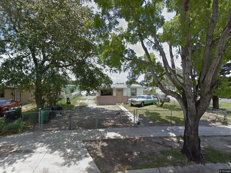 1981 Rutland Street Opa-Locka, FL 33054 - Photo 3 of 3 a view of a tree in front of a white house