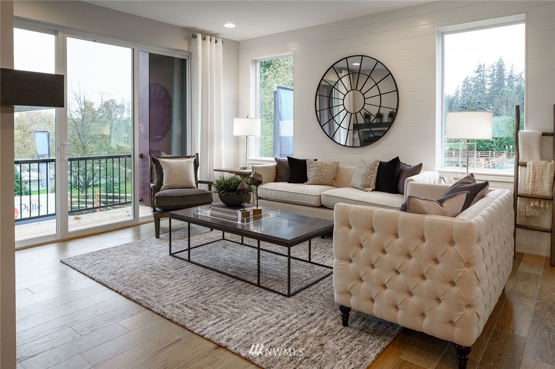 619 238th Street Southeast, Unit A Bothell, WA 98021 - Photo 11 of 21 a living room with furniture a table and a large window