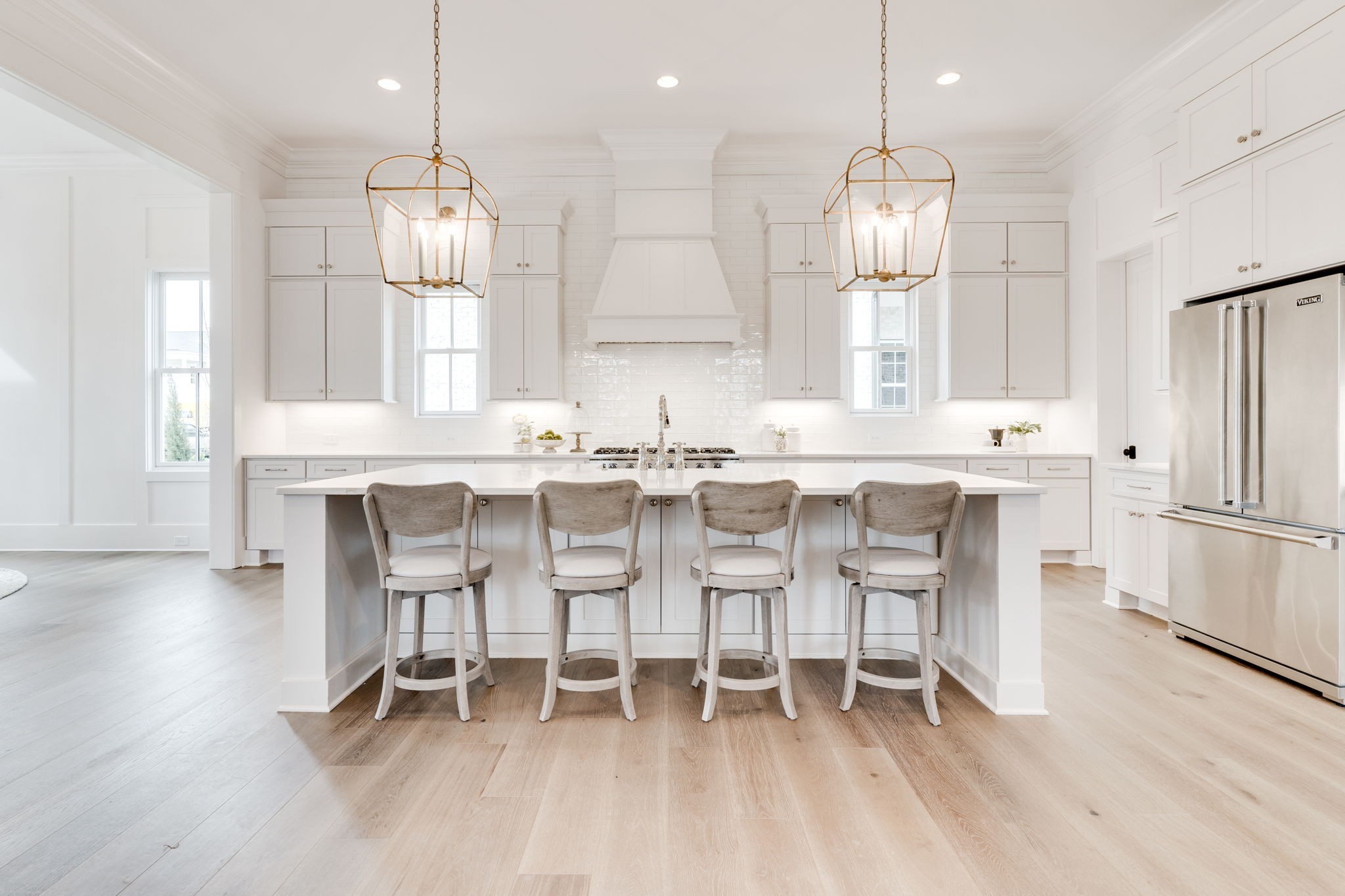 6076 Pasquo Road Nashville, TN 37221 - Photo 19 of 69 a kitchen with stainless steel appliances kitchen island granite countertop a dining table chairs and white cabinets
