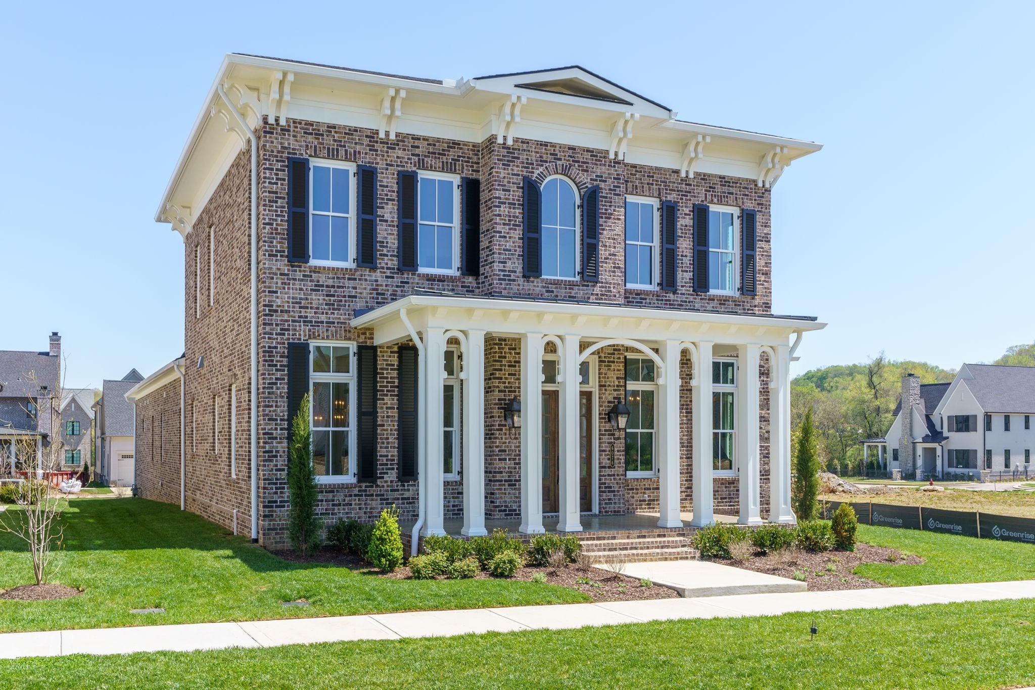 6076 Pasquo Road Nashville, TN 37221 - Photo 2 of 69 a front view of a building with a yard