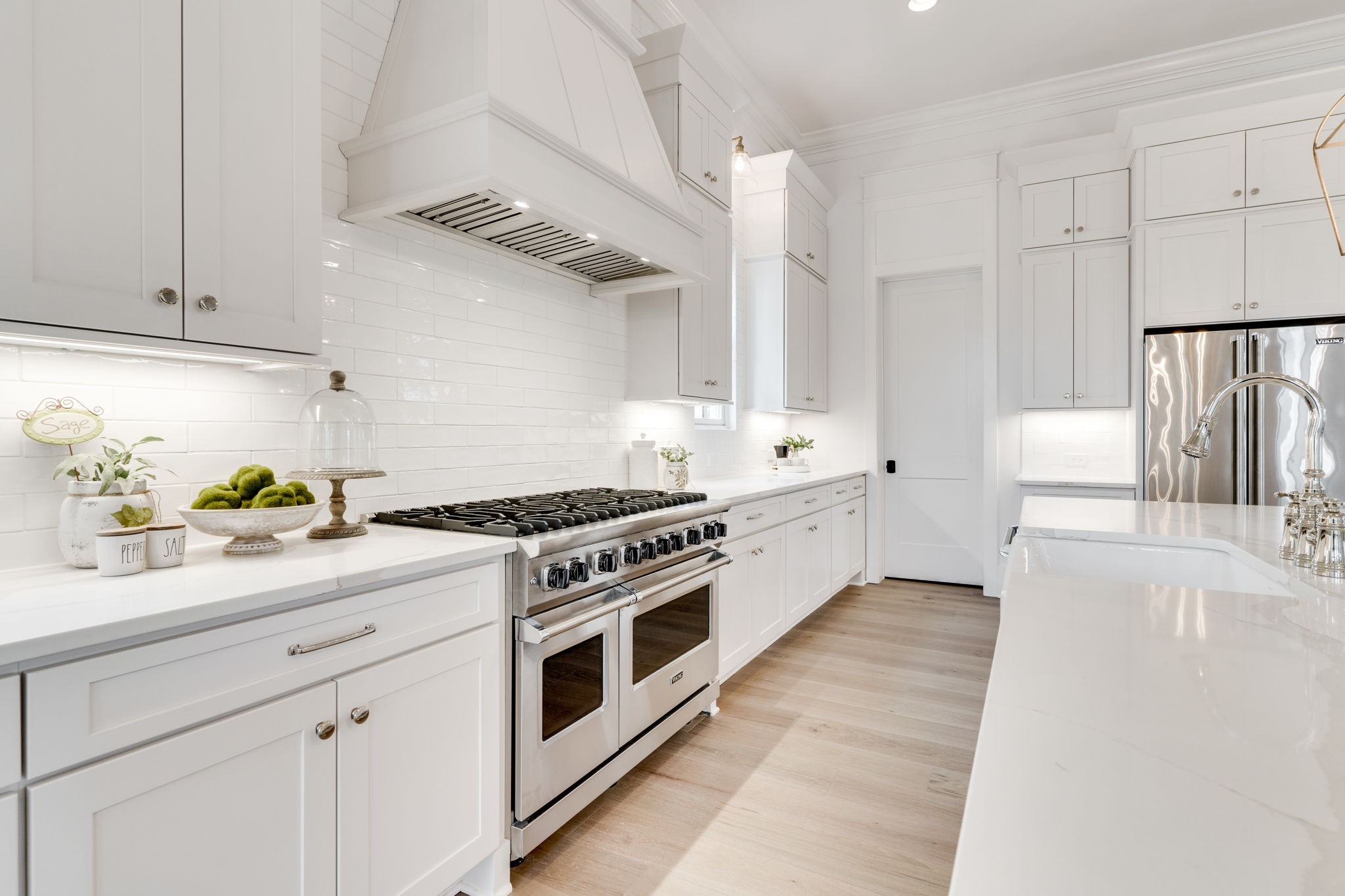 6076 Pasquo Road Nashville, TN 37221 - Photo 22 of 69 a kitchen with stainless steel appliances white cabinets and wooden floors