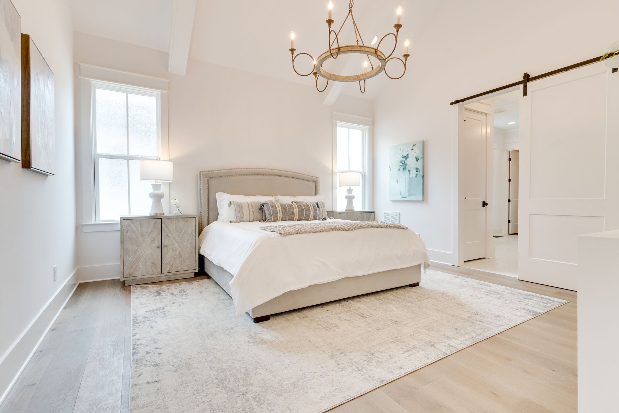 6076 Pasquo Road Nashville, TN 37221 - Photo 31 of 69 a bedroom with a bed and a chandelier