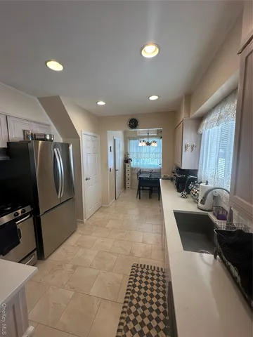 a white refrigerator freezer and a stove in a kitchen
