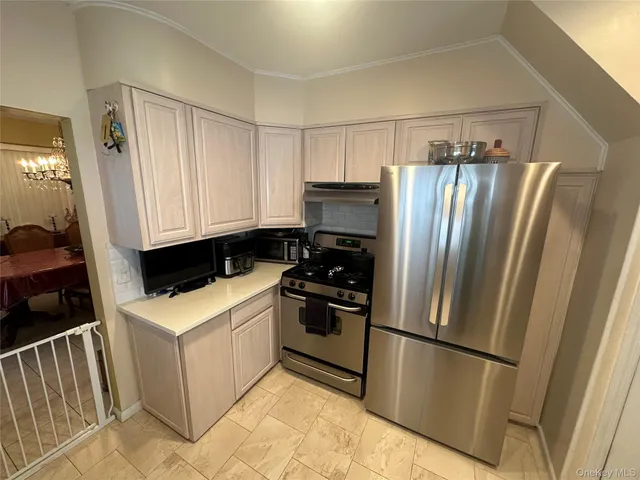 a kitchen with a sink a stove and a refrigerator