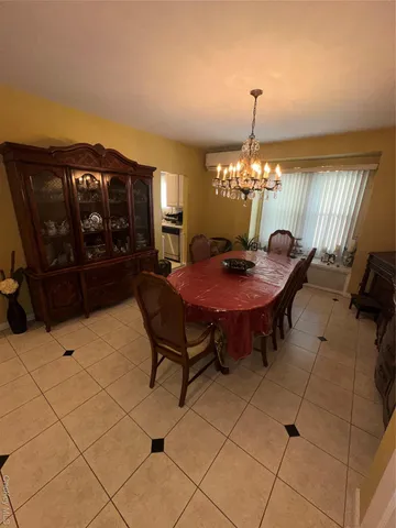 a bed room with a bed chair and a mirror