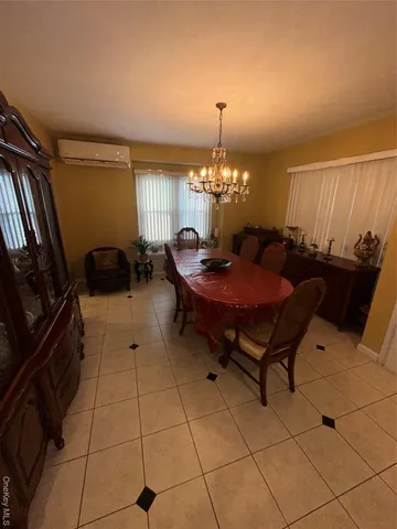 a large bed sitting in a bedroom next to a lamp