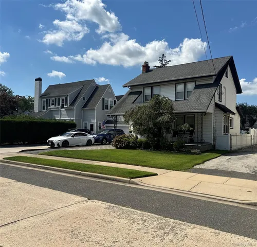 a front view of a house with a garden and porch