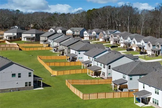 a view of a house with pool and chairs