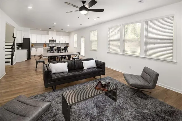 a living room with furniture and kitchen view