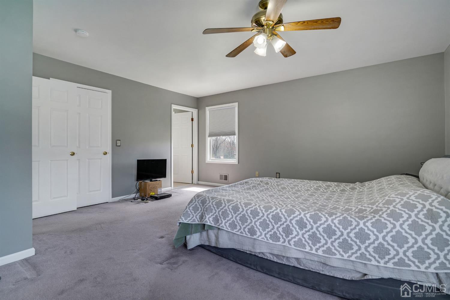 9 Poplar Road Piscataway, NJ 08854 - Photo 22 of 35 a bedroom with a bed and a chandelier