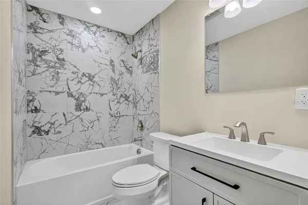 a bathroom with a sink a toilet and a bathtub