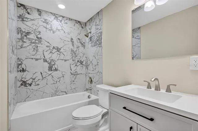 a bathroom with a sink a toilet and a bathtub