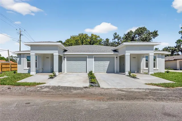 a view of a house with a yard and garage