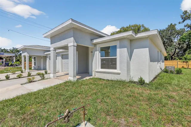 a view of a house with backyard and sitting area