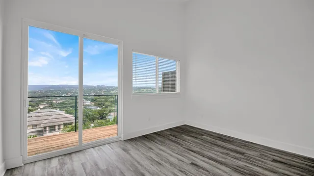 a view of a room with wooden floor