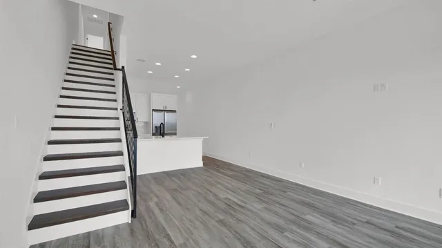 a view of a room with wooden floor and white walls