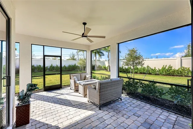 a living room with couch tv and outdoor view