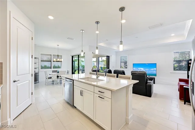 a kitchen with stainless steel appliances kitchen island granite countertop a sink and cabinets