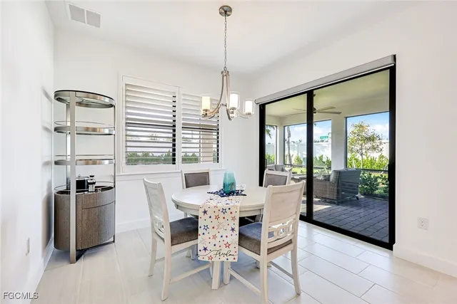 a dining room with furniture a chandelier and fireplace