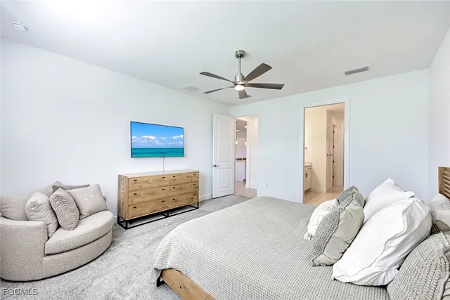 a bedroom with a bed couch and window