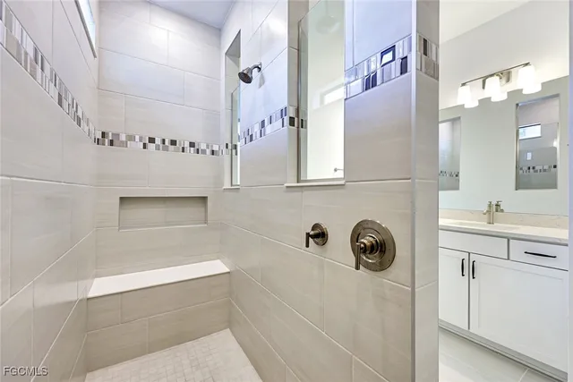 a bathroom with a sink a mirror and shower