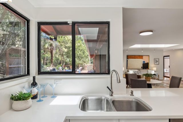 a kitchen with refrigerator cabinets and wooden floor