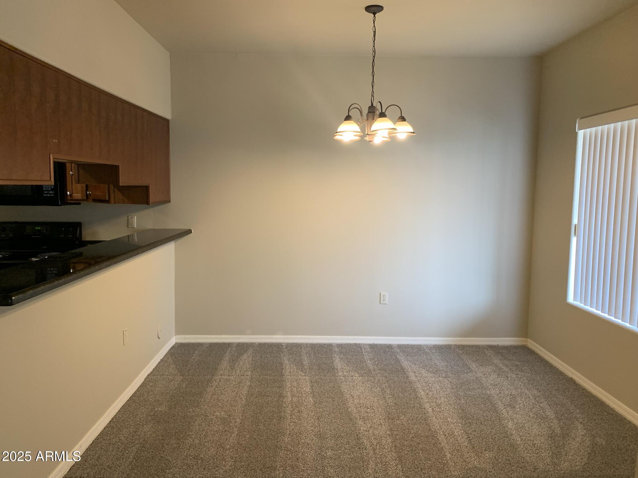 1117 East 8th Street, Unit 3001 Tempe, AZ 85281 - Photo 4 of 16 a view of a kitchen with a dishwasher cabinets and a wooden floor