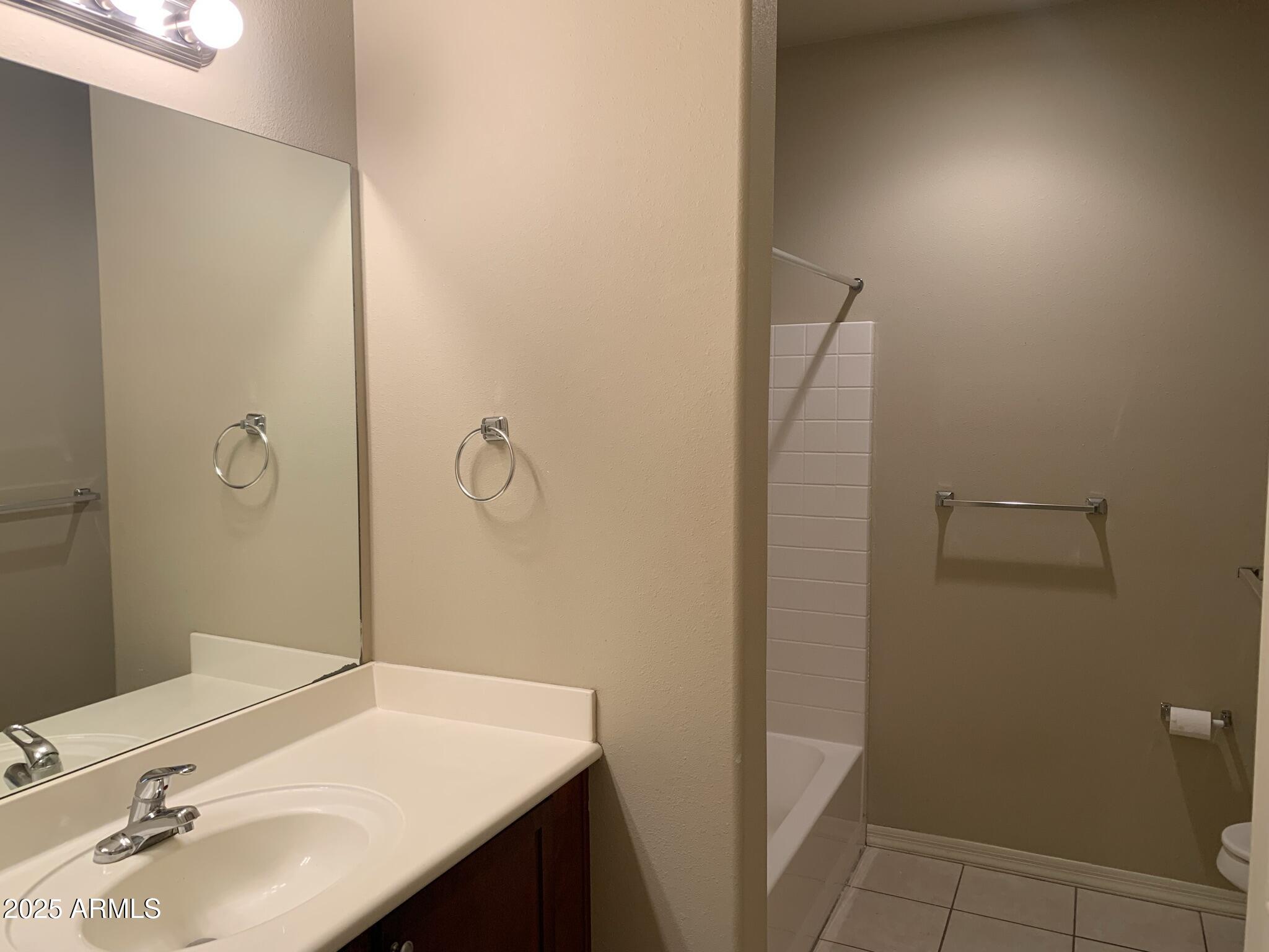 1117 East 8th Street, Unit 3001 Tempe, AZ 85281 - Photo 6 of 16 a bathroom with a sink a toilet and shower