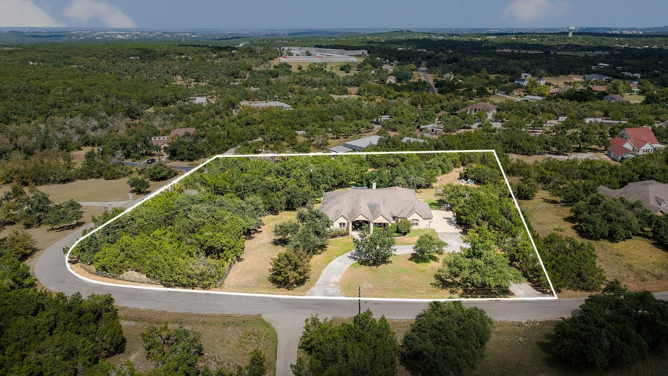 an aerial view of a house with a yard