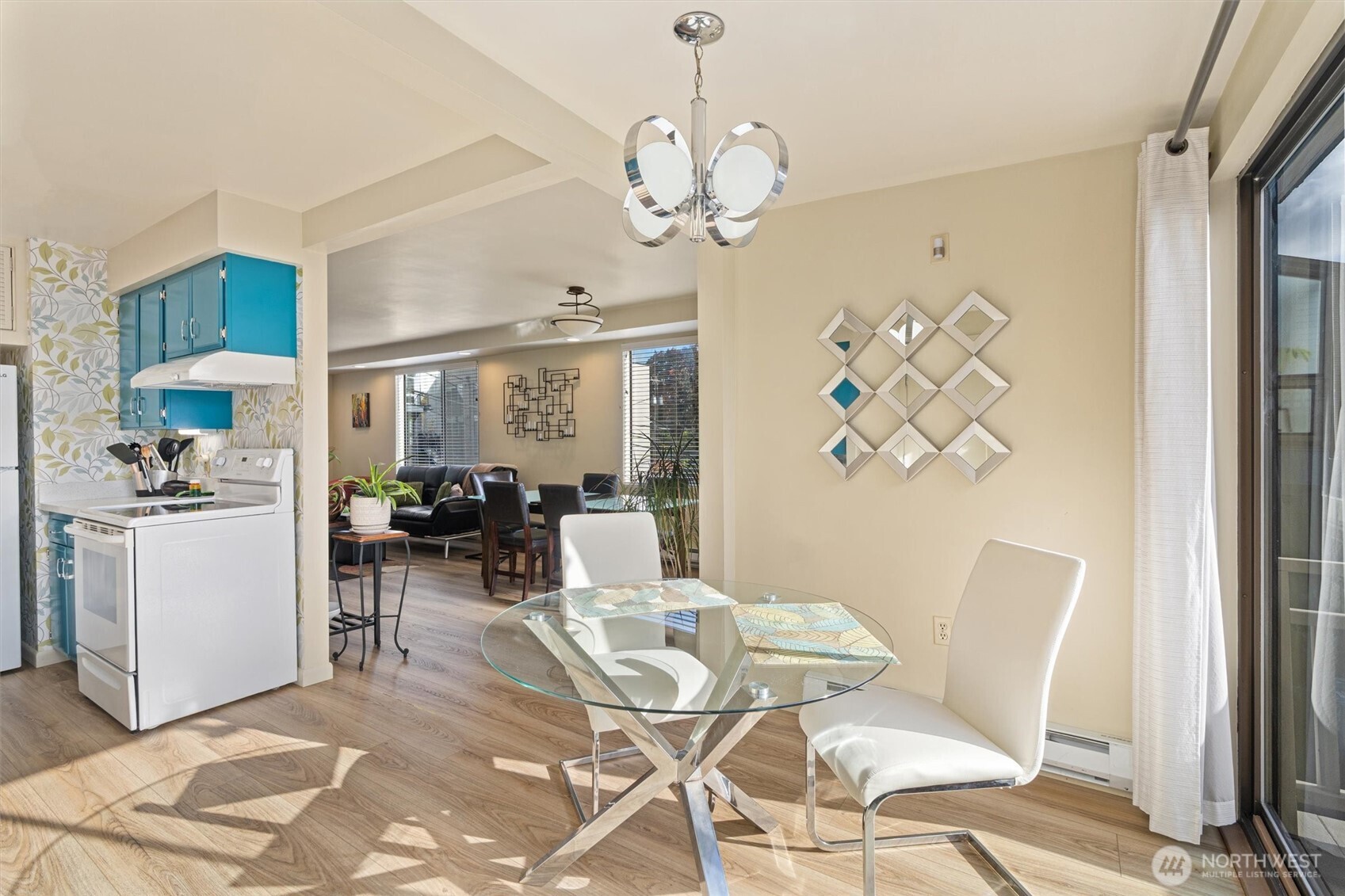 561 Lee Street Seattle, WA 98109 - Photo 12 of 40 a view of a dining room with furniture and a chandelier