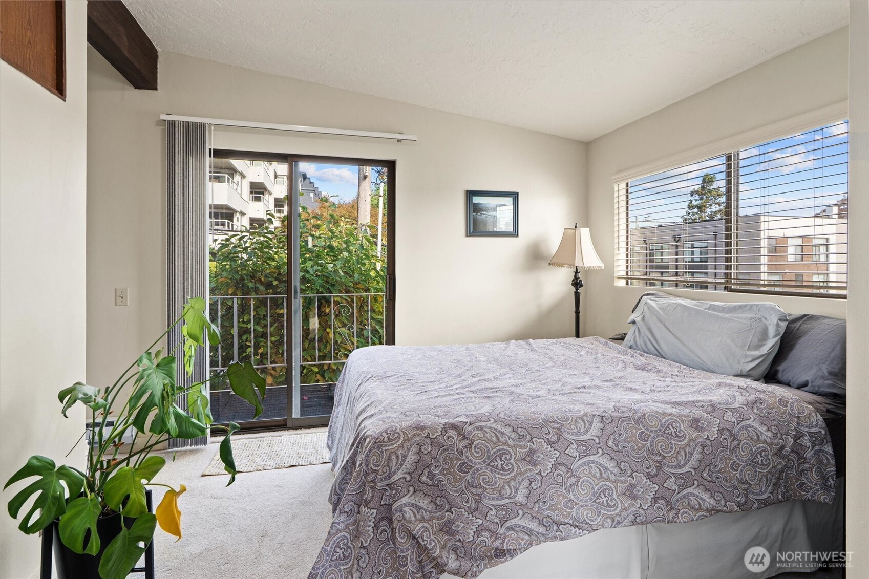 561 Lee Street Seattle, WA 98109 - Photo 19 of 40 a bed sitting in a bedroom next to a window