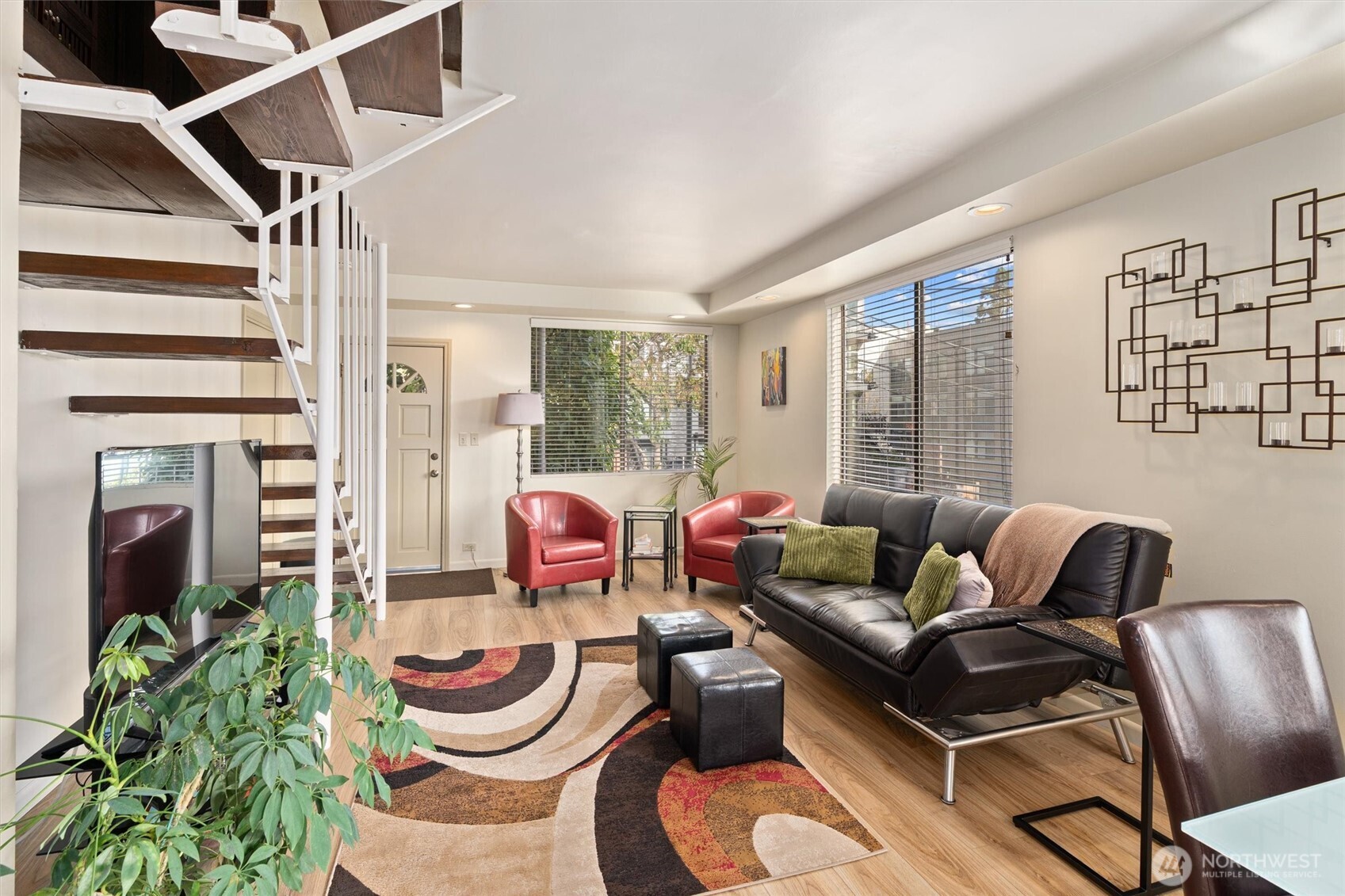 561 Lee Street Seattle, WA 98109 - Photo 6 of 40 a living room with furniture and a floor to ceiling window